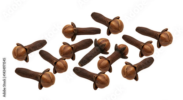 Fototapeta A scattered arrangement of dried cloves displayed against a stark black background in a studio shot