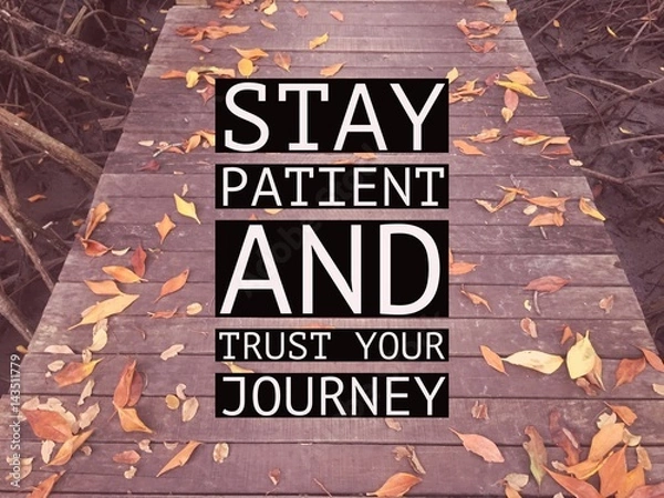 Obraz Inspirational motivational quote “stay patient and trust your journey” on wooden walkway with autumn leaves background.