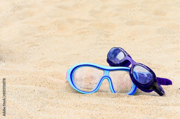 Fototapeta Diving goggles on the sand at the seaside.