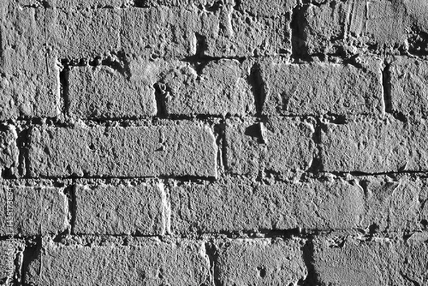 Obraz Fragment of brickwork, close-up. Brick wall, close-up. Potholes and defects in a brick wall, flat layout. Cracks and defects in bricks on a wall, color fantasy.