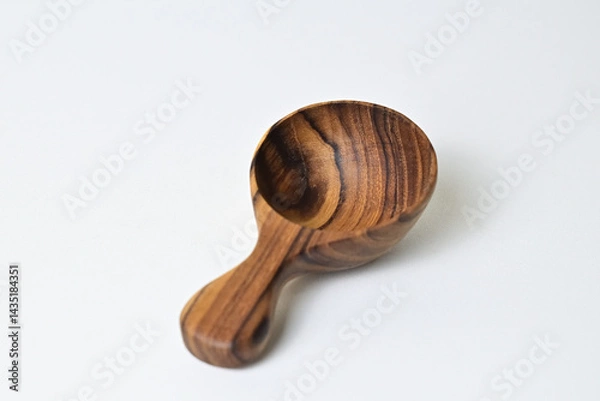Fototapeta Photo of One (1) empty little wooden spoon isolated on white background. Clipping path. Close up view.