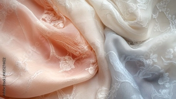Fototapeta Close-up of draped pastel silk fabrics with embossed floral patterns.