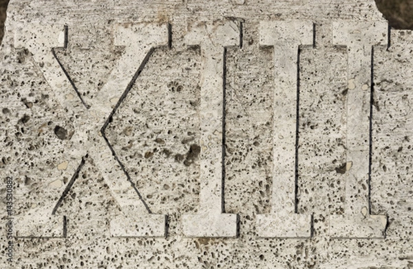 Obraz Roman numerals on marble plate, thirteen