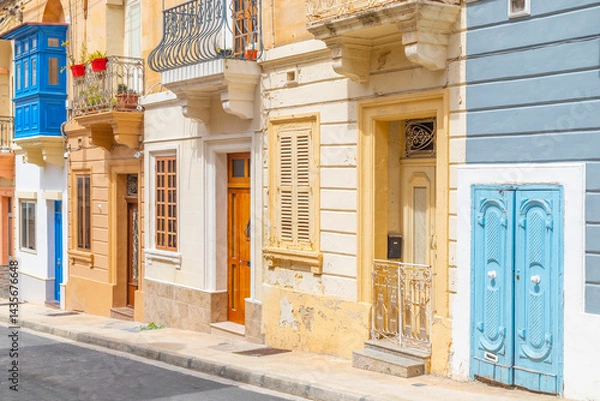 Obraz View of a typical Maltese street with old residential buildings in traditional architectural style, Malta
