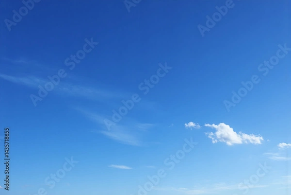 Fototapeta blue sky with some white clouds in it