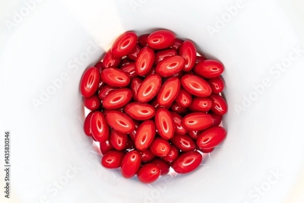 Fototapeta Red pills and supplements inside white jar