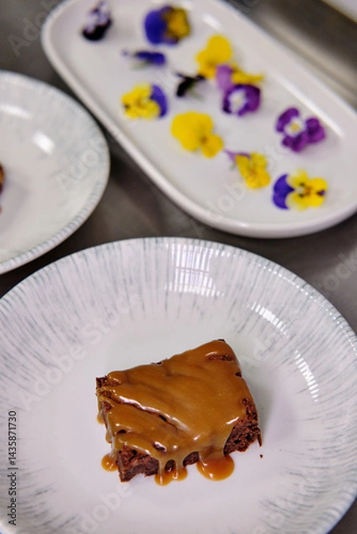 Obraz Elegant dessert garnished with edible flowers on a porcelain plate