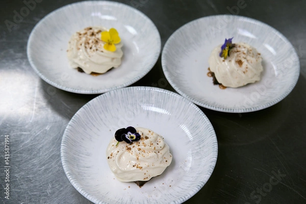 Obraz Elegant dessert garnished with edible flowers on a porcelain plate