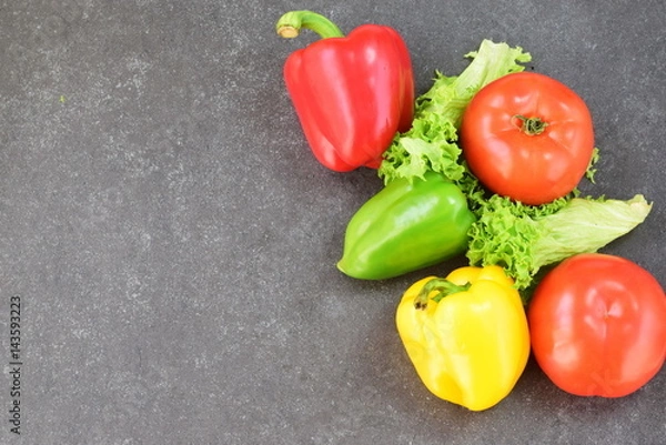 Obraz Fresh vegatables: paprika, tomato, onion,onion, carrot on a rustic textile cloth on a grey wooden background. Healthy eating concept. Place for text.