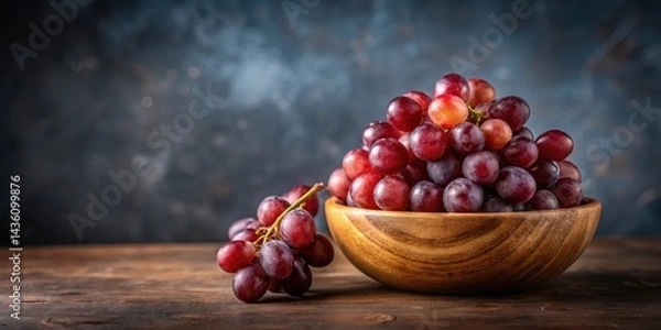 Fototapeta Fresh red grapes arranged artfully in a small wooden bowl with a minimalist background , natural, wood,  natural, wood, still life