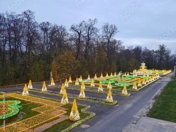 Obraz Panoramic photo of  the winter illumination in the garden of the Wilanów Palace in Warsaw