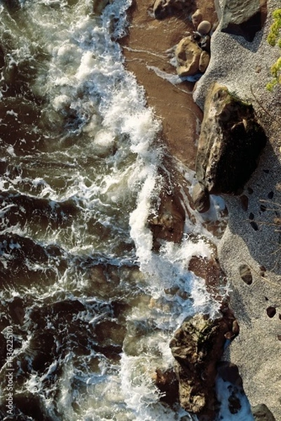 Fototapeta Stones among the ocean foam. Close-up. Freshness. Textures. Top View. Abstract background