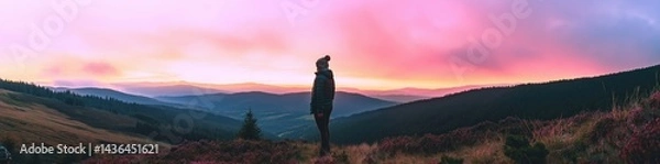 Fototapeta Happy woman standing with her back on sunset in nature . Panoramic view of a colorful sunset created by ai