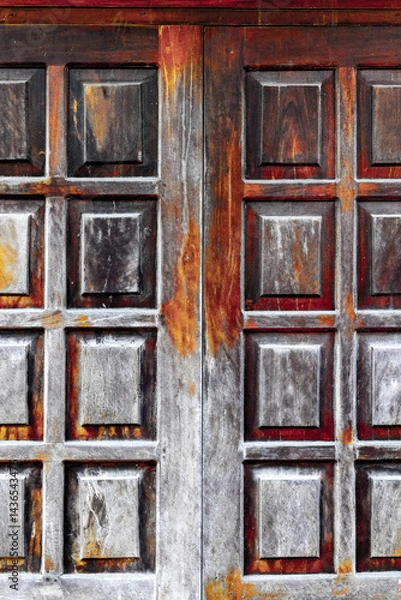 Obraz Ancient wooden door with weathered texture and rich rustic colors