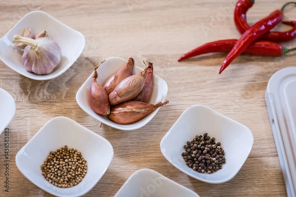Obraz Spices arranged in bowls during cooking pilaf. Background of the kitchen interior.