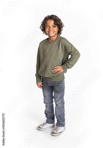 Obraz A casual studio portrait of a cute, smiling, diverse bi-racial boy standing. Isolated on a white background. Real person concept photo