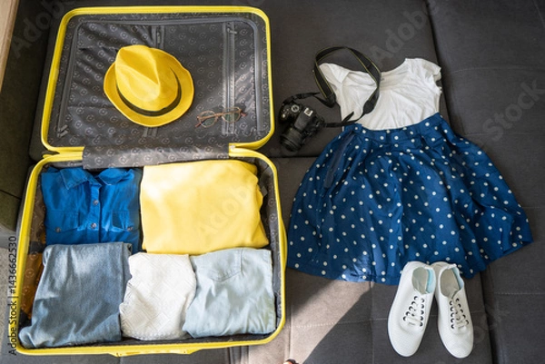 Obraz Travel Wardrobe Packing – Open Suitcase and Outfit Flat Lay