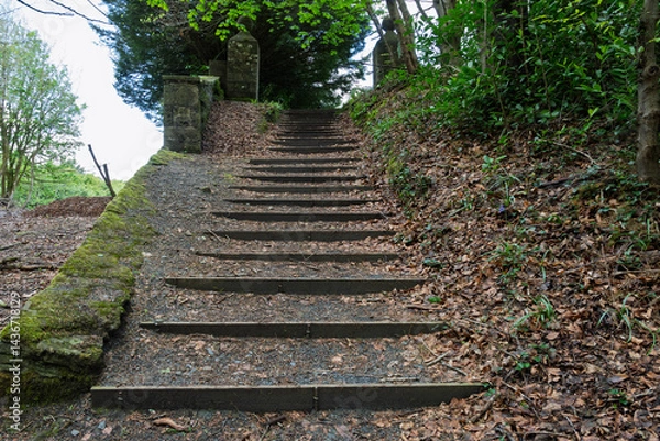 Fototapeta A staircase with a wooden railing and a stone pillar