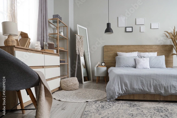 Fototapeta Interior of beautiful bedroom with chest of drawers, shelving unit and mirror