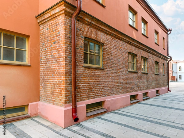 Fototapeta old industrial building after renovation. fragment of an old bricklaying is saved.