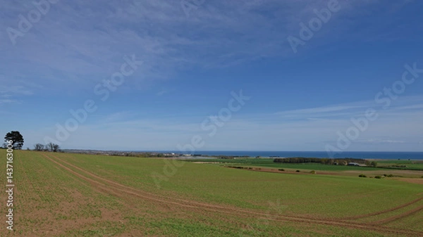 Obraz The view across the sloping Farmland at the Mains of Kelly over to the coast and the outskirts of Arbroath in the far distance.