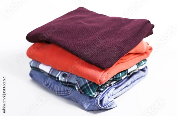 Obraz pile of bright folded clothes. White background