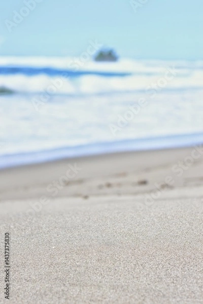 Fototapeta defocused image of Beautiful view of a tropical beach with clear blue sky, turquoise ocean waves, and a small island