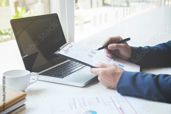 Fototapeta Business concept. Business people discussing the charts and graphs showing the results of their successful teamwork.