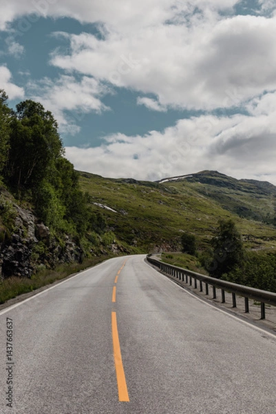 Obraz View from a car window onto a highway in Norway in a mountain valley where metal barriers have been installed for safety purposes