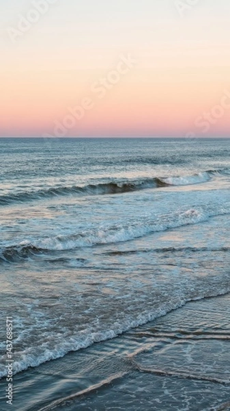 Fototapeta Rich teal ocean with foamy waves and soft pastel sunset sky creating dreamy seascape
