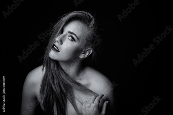 Fototapeta red head model with an edgy personality looking sexy in a dark studio with edgy lighting