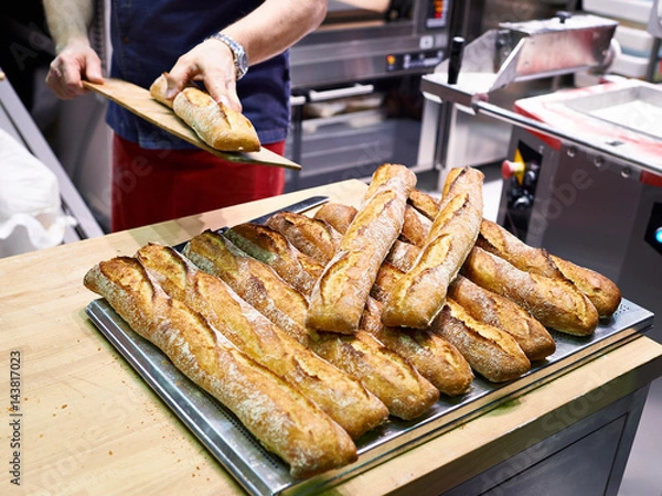 Fototapeta Baker with freshly baked bread