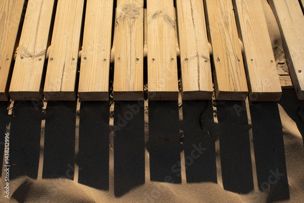 Obraz Plank walk on the sand of the beach, with shadows elongated by the afternoon light, Valencian Community, Spain