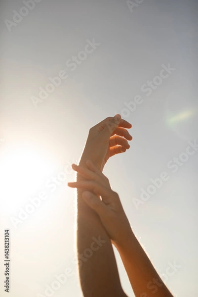 Obraz The silhouette of a young woman's hands, seem to dance as they caress each other under the rays of the afternoon sun, Mediterranean, Spain