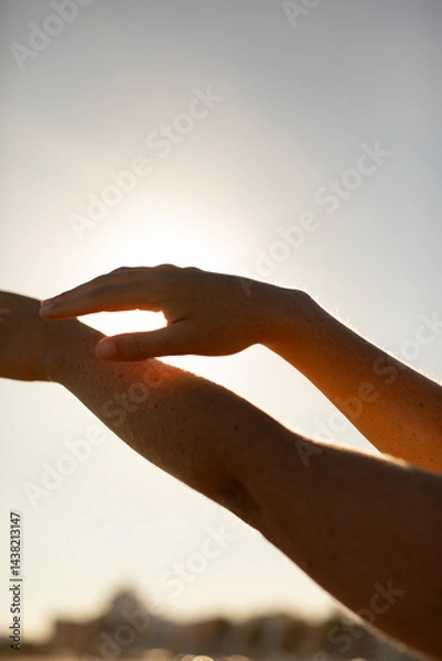 Obraz The silhouette of a young woman's hands, seem to dance as they caress each other under the rays of the afternoon sun, Mediterranean, Spain