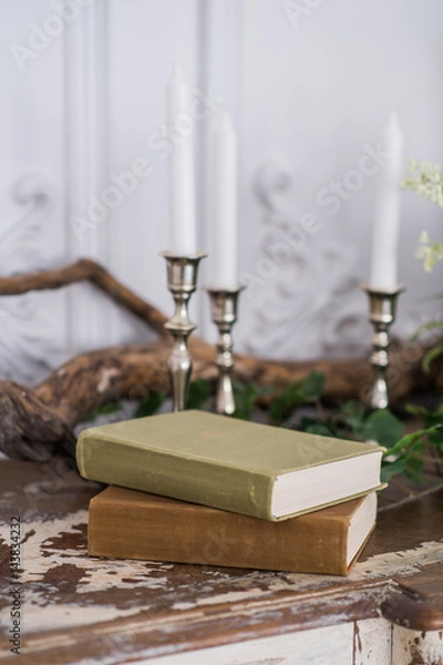 Obraz Romantic autumn scenery for photo shoots. Old books, green branch, candles
