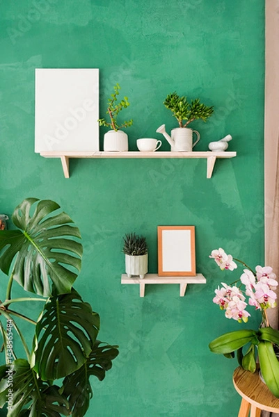 Fototapeta white small frame mockup on shelf with decoration objects, rustic green wall