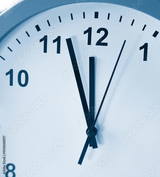 Fototapeta Clock face pointing to twelve o'clock