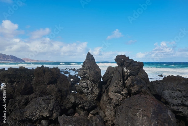 Obraz Caleta del Mojon Blanco beach on Atlantic Ocean with volcanic relief, big sharp rocks, big waves in Lanzarote, Spain