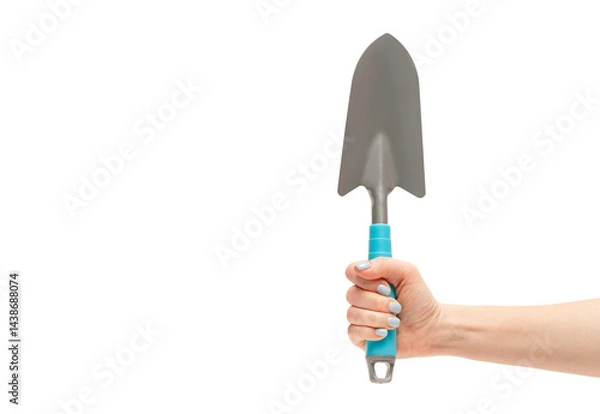 Obraz Female hand holding garden shovel, isolated on white