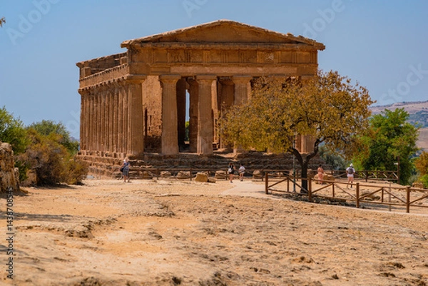 Fototapeta Tourists exploring Valley of the Temples (Valle dei Templi) Temple of Concordia, Agrigento, Sicily, Italy. Travel and sightseeing journey concept