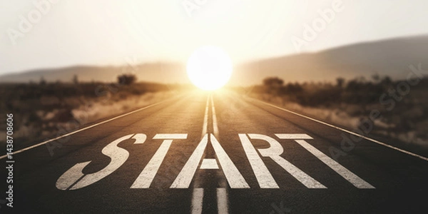 Fototapeta Asphalt road stretching towards bright sun, "START" painted on surface, symbolizing new beginnings, journey, ambition, and success