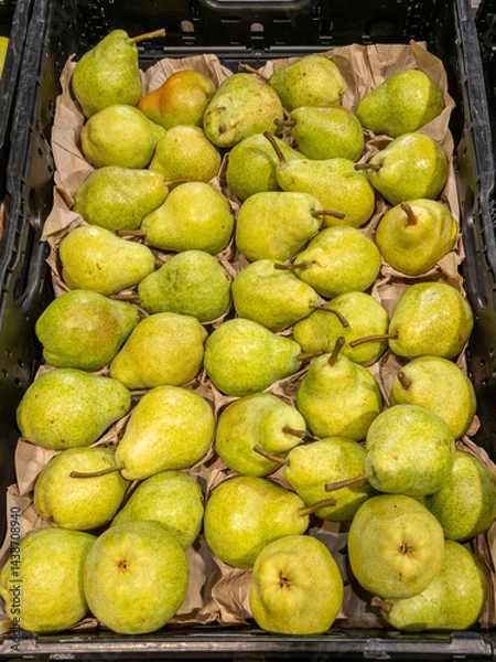 Fototapeta White Williams pears arranged in a crate on a greengrocer's shelf