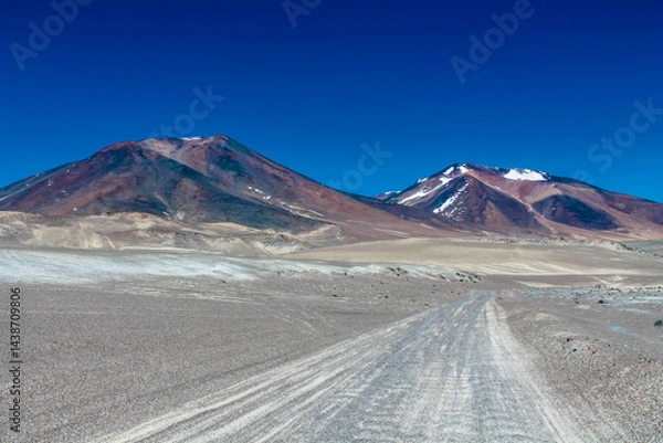 Fototapeta Ojos del Salado volcano mountain in Chile. Volcanic mountain landscape in arid dry altiplano high altitude plains, volcano high summit in Atacama desert arid soil and sand under blue sky with no cloud
