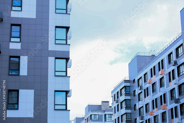 Obraz The concept of modern architecture, residential complex, apartment buildings for living. Multi-storey, apartment buildings of the residential complex in a single architecture in gray and white tones