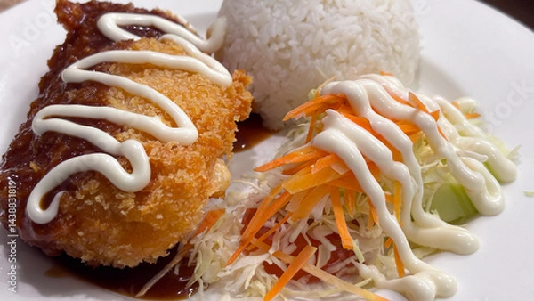 Fototapeta Close-up of Chicken Katsu meal with rice and salad, topped with sauce and mayo