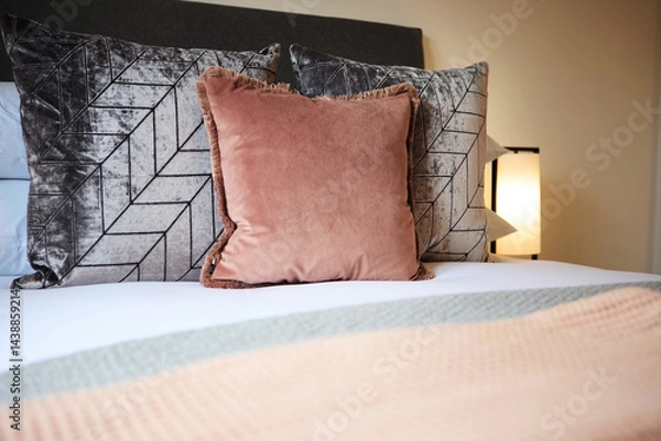 Obraz Pillows, fabric and interior design of bedroom with duvet, comforter or patterns for hotel accommodation. Closeup of empty room, house or apartment at resort with stylish cushion, linen or home decor
