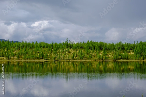 Fototapeta Sunset panorama of small lake with mountain reflection in Siberia, Buryatia, Russia