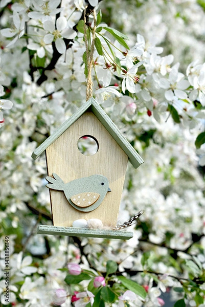 Obraz Wooden birdhouse decor hanging on spring apple tree blossoms