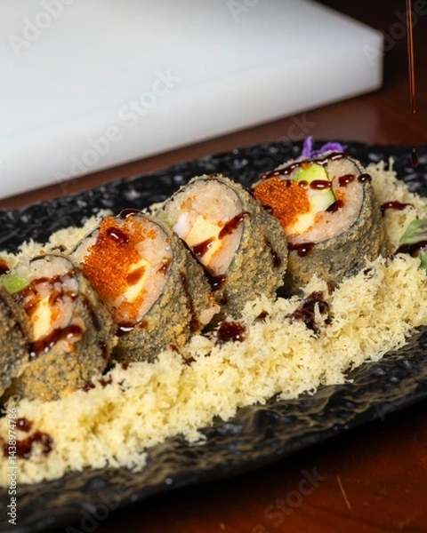 Fototapeta Savoring sushi rolls culinary delight in an elegant restaurant setting gourmet food photography indoor ambiance taste adventure